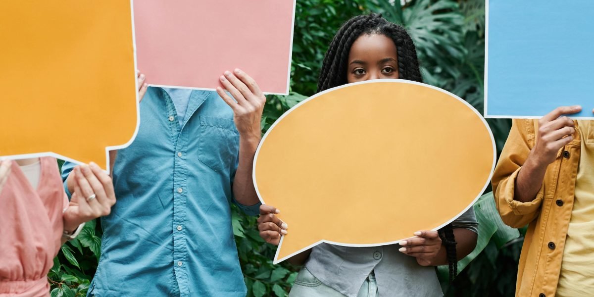 Diverse individuals engage in conversation, highlighting the importance of cultural sensitivity in understanding mental health terminology.