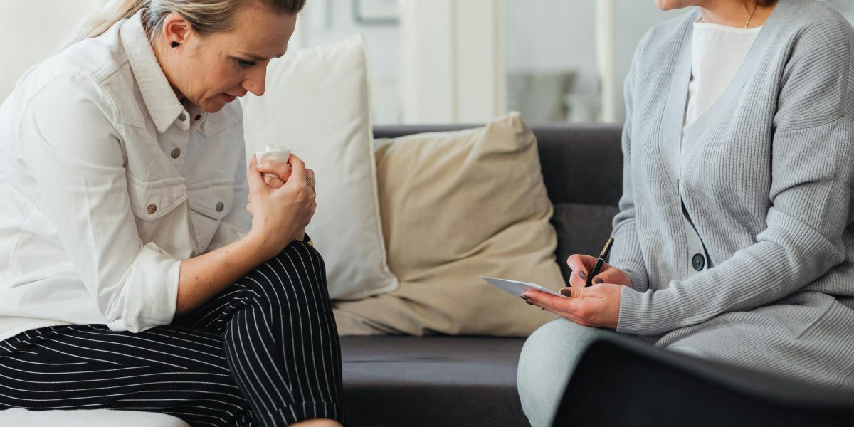A person having a serious conversation with a compassionate professional.