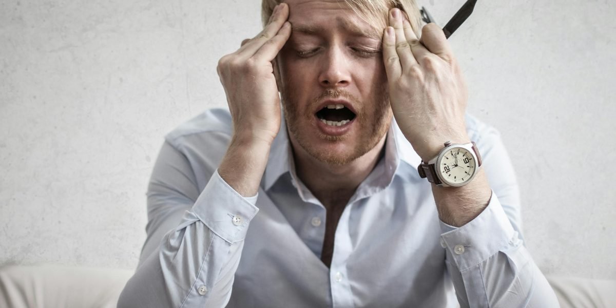 A person looking overwhelmed, symbolizing the emotional and cognitive load of anxiety.