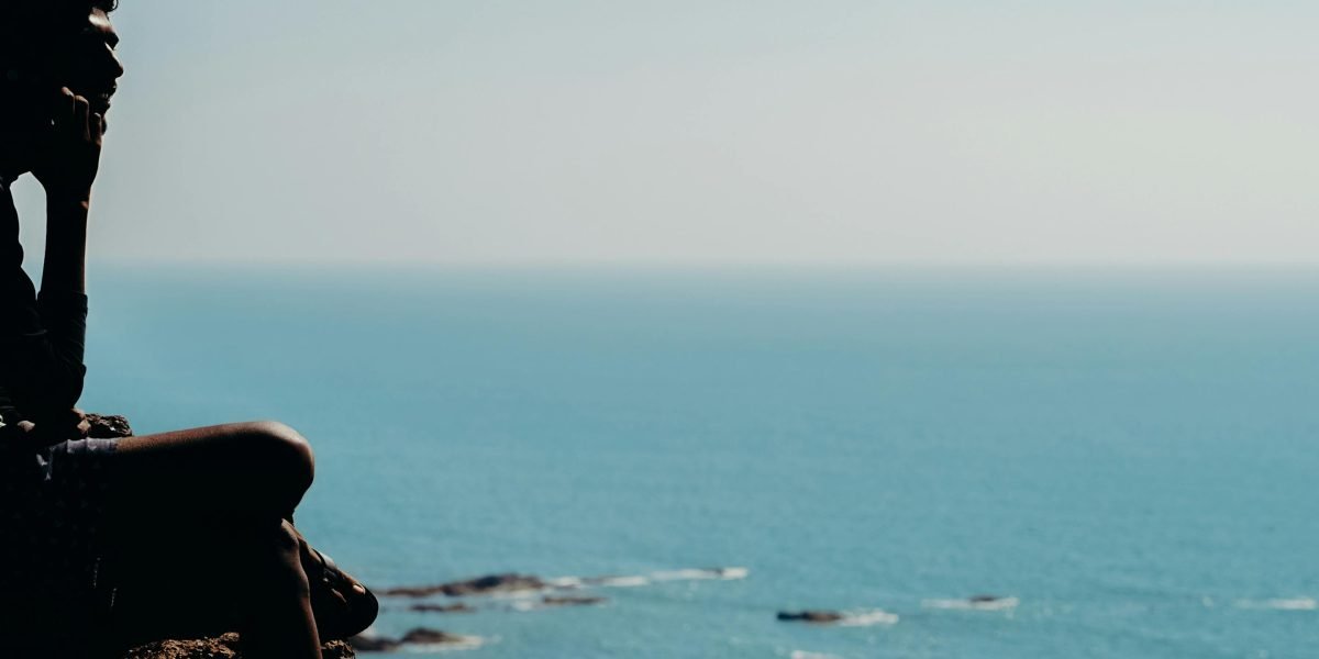 A person in a calm, reflective pose, symbolizing the initial step of acknowledging trauma and seeking help.
