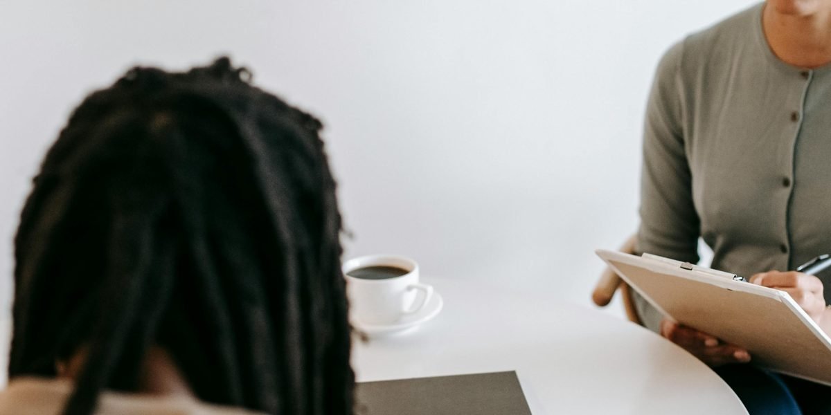 A therapist and client engaged in a collaborative discussion, emphasizing trust and mutual effort in the therapeutic process.