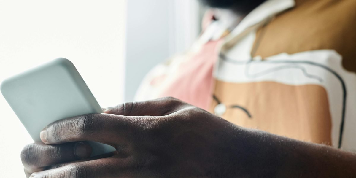 A person using a mobile phone to engage with a digital wellness app, finding calm and support.