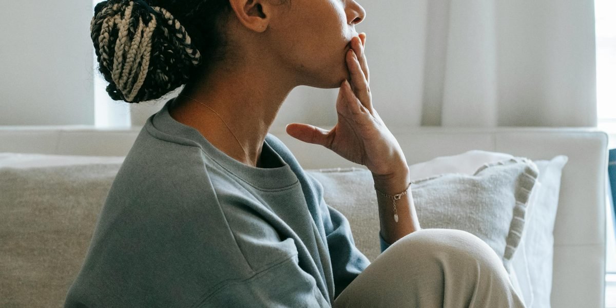 A person appears deep in thought, perhaps contemplating worries or anxious scenarios, illustrating cognitive patterns.