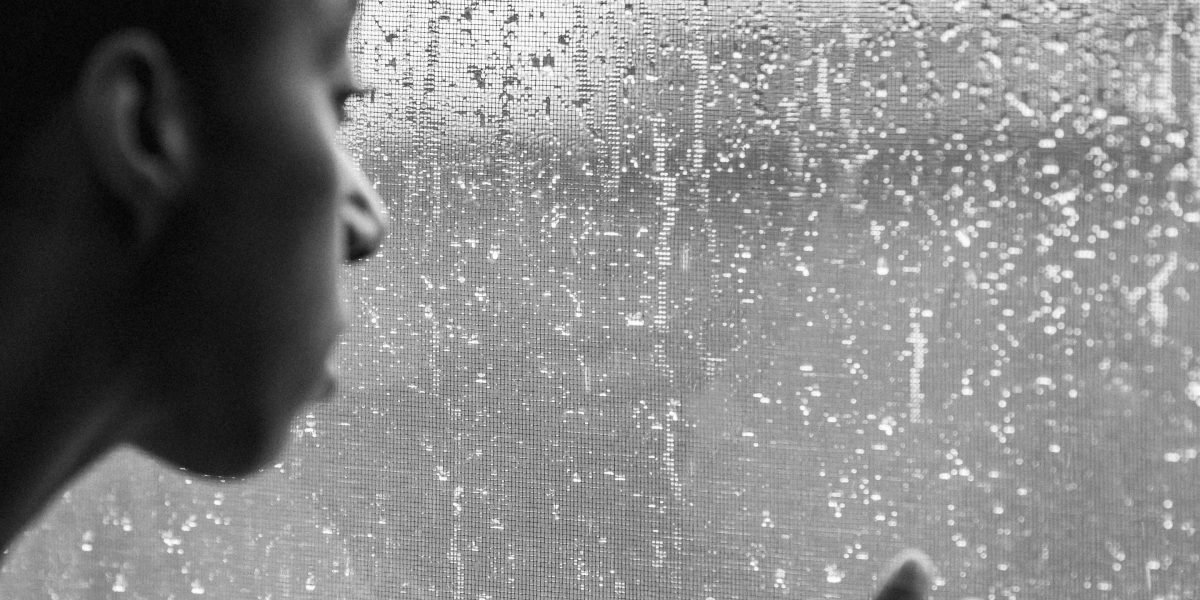 A person reflecting thoughtfully, representing the confusion and internal experience of dissociative symptoms.