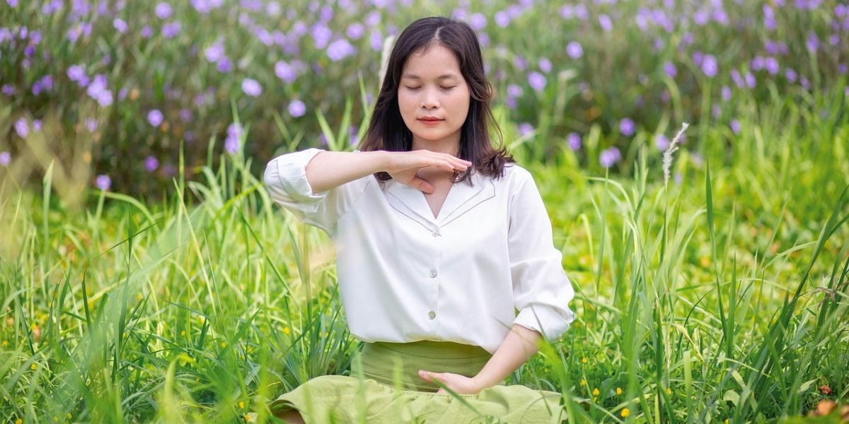 An individual practicing mindful deep breathing, a technique to calm the body and mind and reduce anxiety.