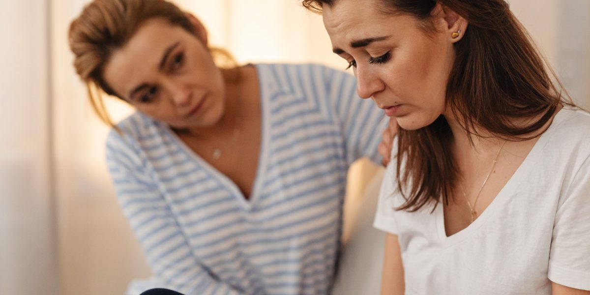 Depicting an individual finding comfort and support during a therapy session, a key step in healing from trauma bonds.