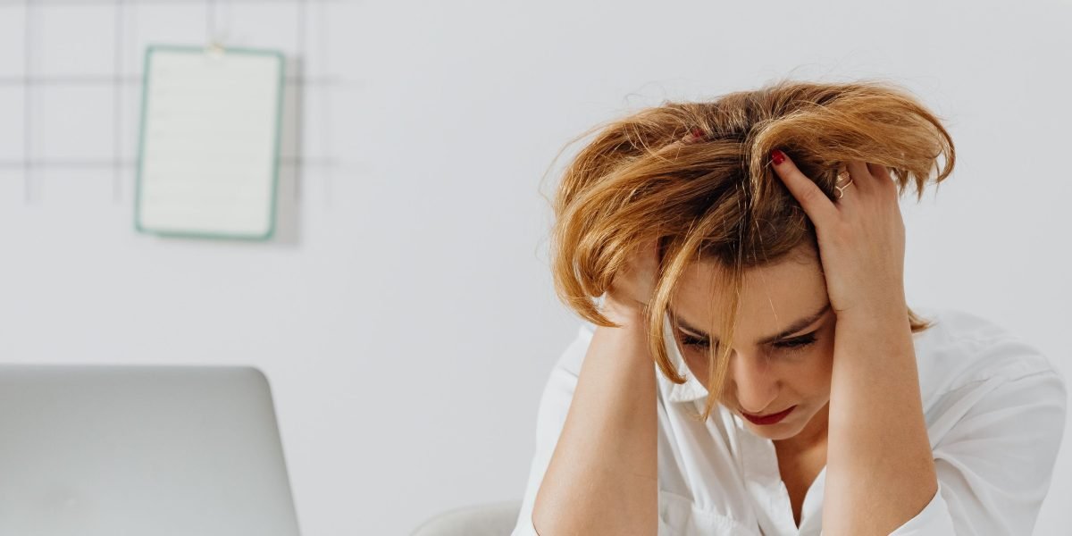 A person experiencing irritability and emotional overwhelm due to persistent anxiety.