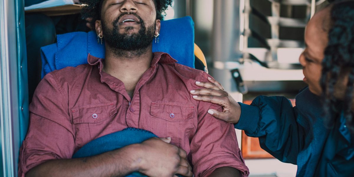 A person in a moment of distress, reaching out for help or comfort, symbolizing the need for urgent care.