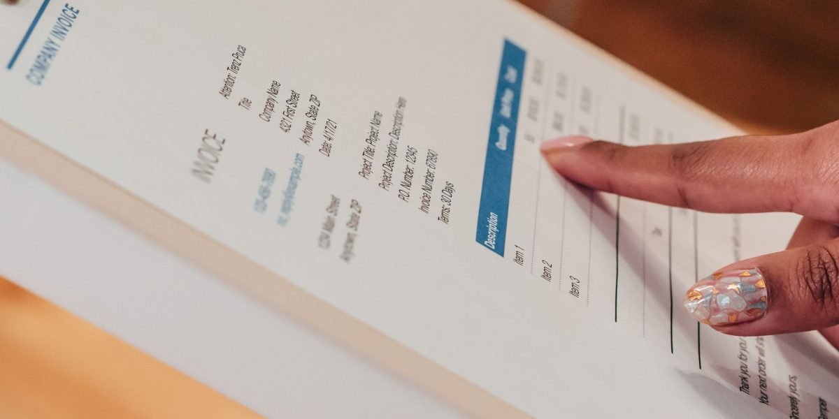 A person carefully organizing papers and notes, symbolizing preparation and clear communication for a medical appointment.