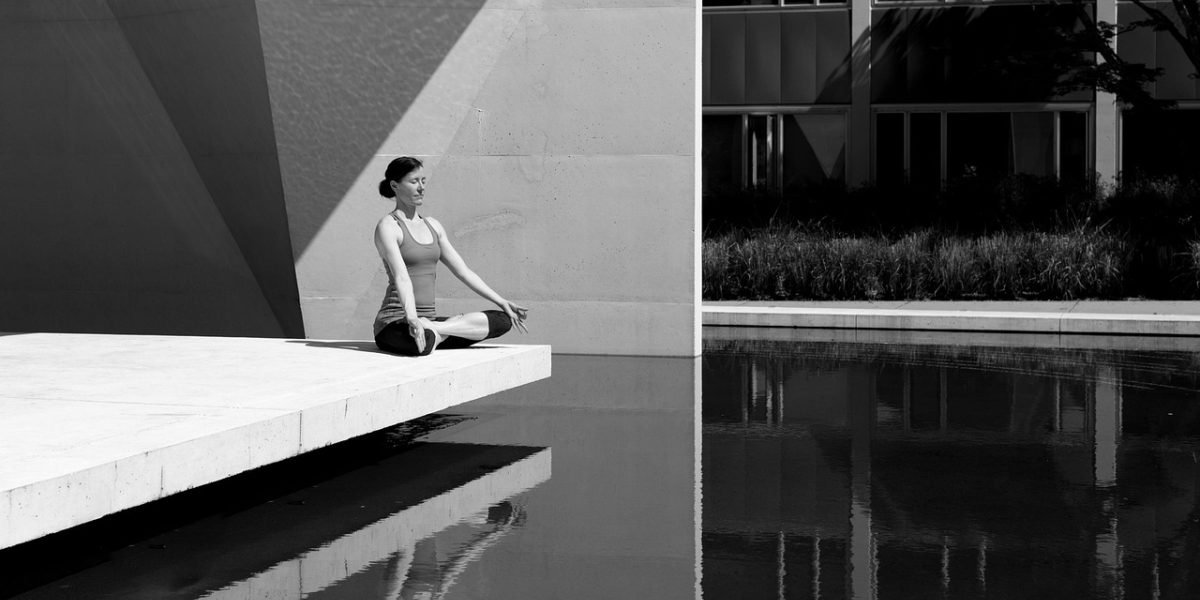 An individual practices a calming exercise, demonstrating a technique to manage stress and strong emotions.
