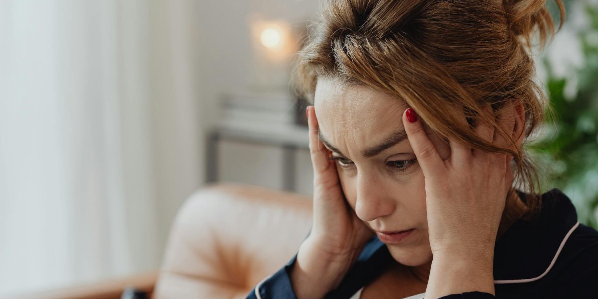 A person feeling burdened by unexpressed emotions, trying to cope with inner turmoil.