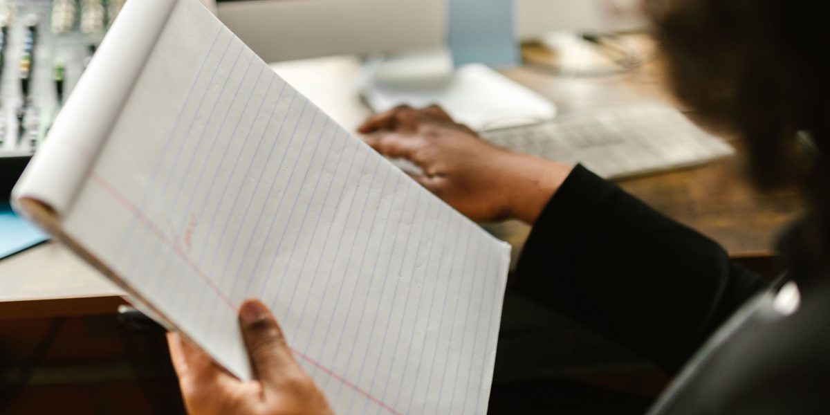 A person meticulously organizing notes and papers, illustrating the preparation needed before seeking mental health care.