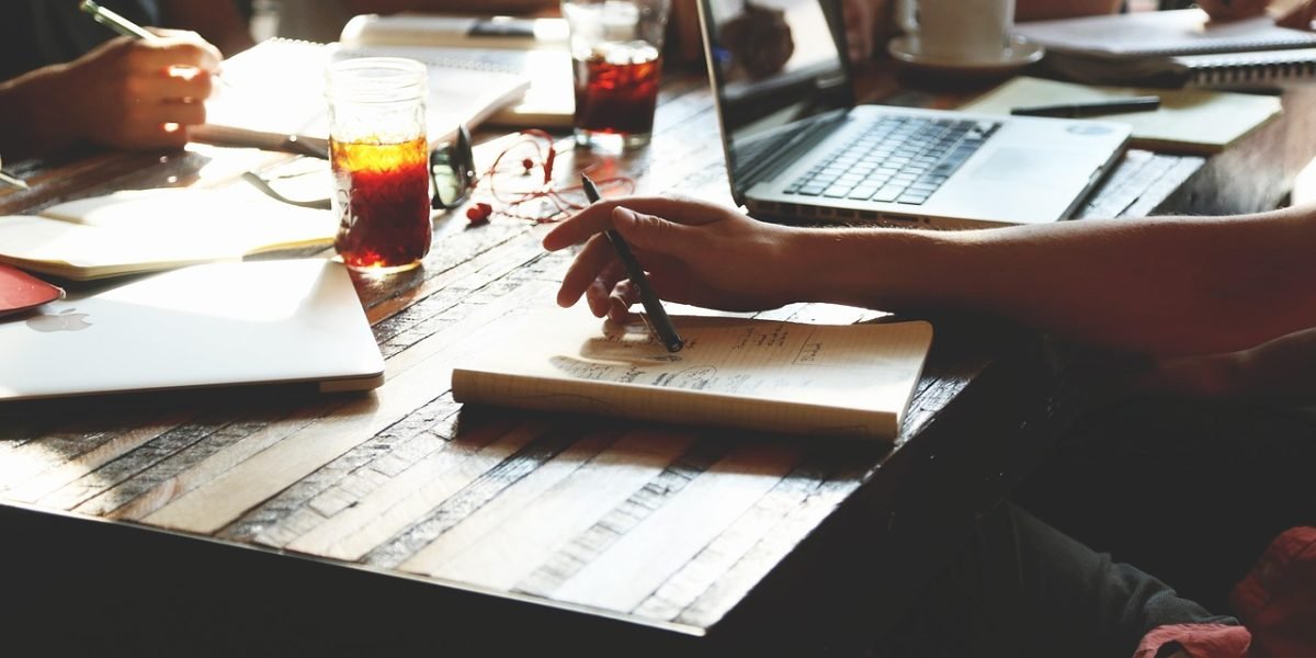 A person diligently writing notes, preparing for an important conversation or their first therapy appointment.