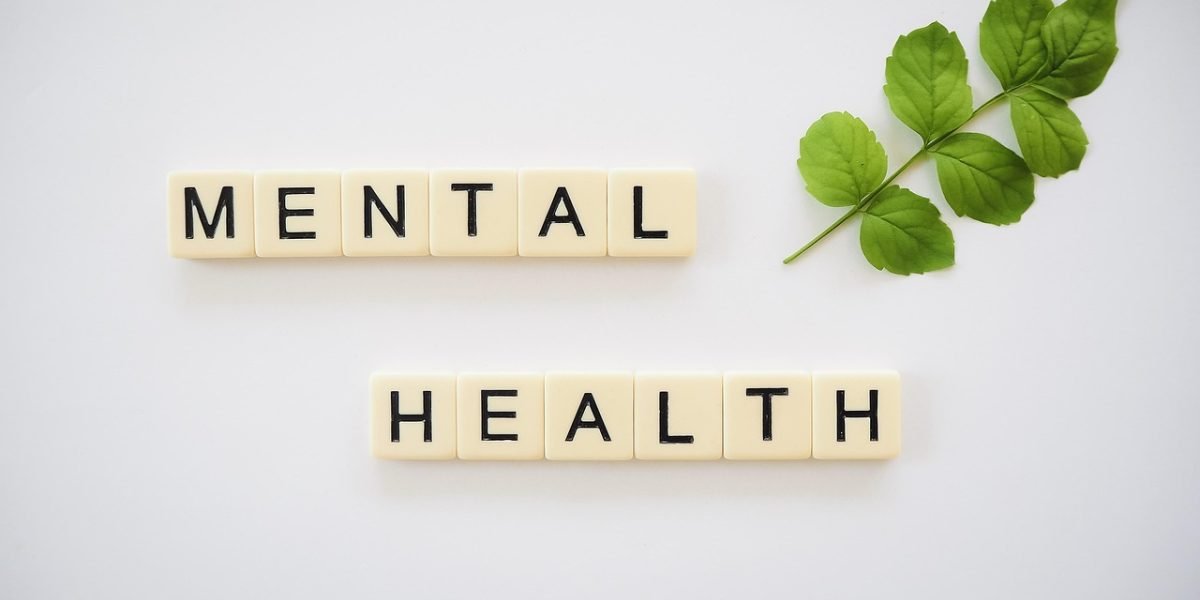 People engaged in an open and supportive conversation about mental health, breaking down stigma.