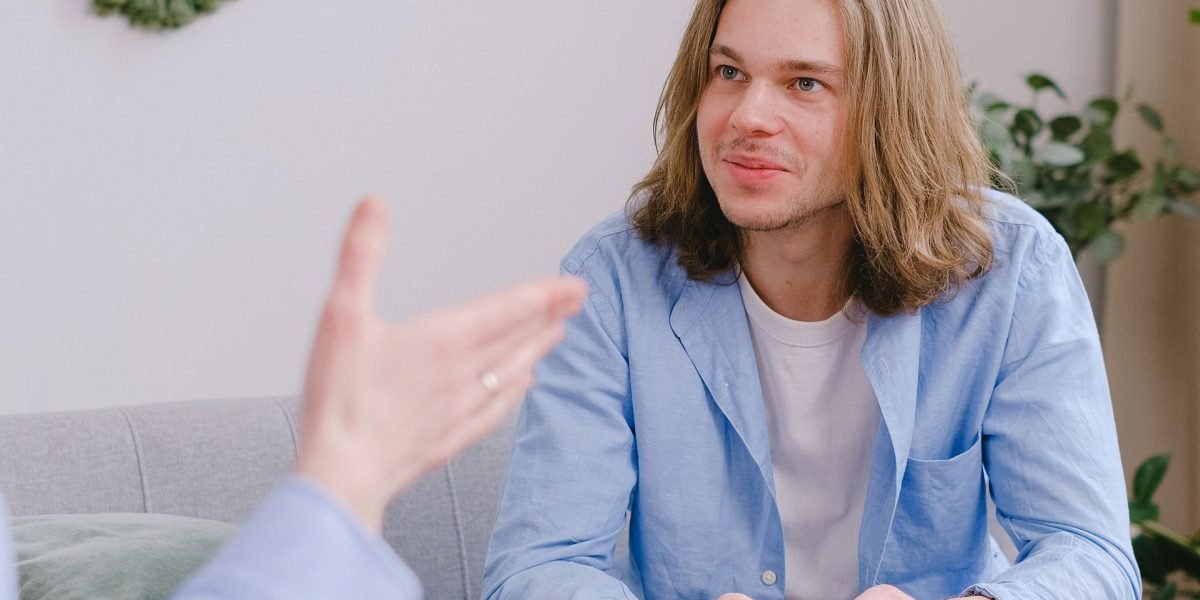 A person engaging in a calm and open conversation with a mental health professional.